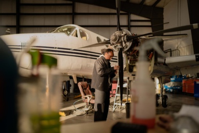 A Fast Air maintenance employee working on a plane.