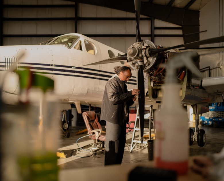 A Fast Air maintenance employee working on a plane.